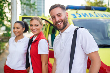 Multi-ethnic paramedics standing at the fromt of an ambulance. Emergency doctor and nurse standing in front of ambulance