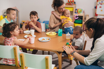 children have breakfast in kindergarten - obrazy, fototapety, plakaty
