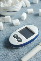 Close up of diabetic measurement tools and sugar cube on table 