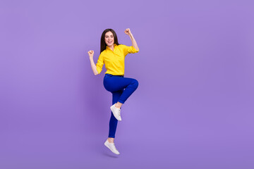 Fototapeta na wymiar Full length body size view of attractive cheery girl jumping rejoicing good mood isolated over bright violet purple color background