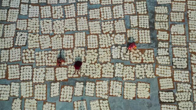 Aerial view of Women at work on the preparation of natural fabric, Barga, Rajshahi, Bangladesh.
