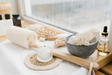 A composition with spa accessories on the white windowsill of a beauty salon. Body care