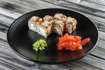 Colorful sushi with shrimp, cucumber, cream cheese. Next wasabi and soy sauce.