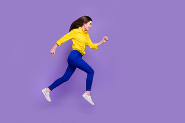 Full length body size view of attractive cheery girl jumping running copy space isolated over bright violet purple color background