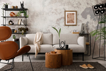 The stylish compostion at living room interior with design gray sofa, armchair, woooden coffee table, lamp and elegant personal accessories. Loft and industrial interior. Template.