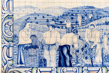 panels of azulejos, tiles, showing the grape harvest in the vineyards at the railway station of Peso da Regua, Portugal