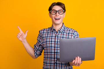 Portrait of attractive cheerful smart brunet guy agent broker hold hands laptop work isolated over bright color background