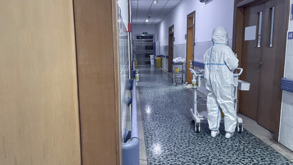 Doctor in protective suit in hospital corridor