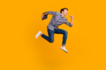 Fototapeta na wymiar Full size photo of funky man jump use laptop search social media online wear casual style clothing isolated over bright background