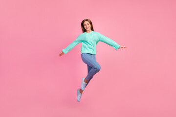 Fototapeta na wymiar Full length portrait of excited cheerful person arms wings flying jumping isolated on pink color background