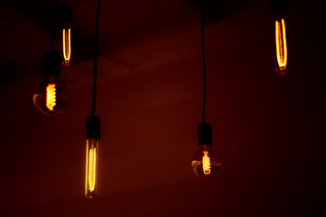 Group of tungsten light bulbs in the dark.