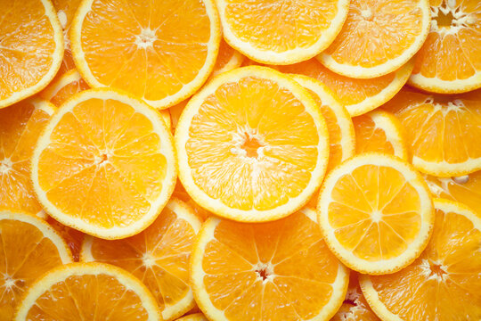 Close up image of orange slices. Orange background.