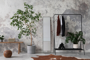 The stylish compostion at living room interior with concrete wall, hanger mirror, wooden bench and elegant personal accessories. Loft and industrial interior. Template. .