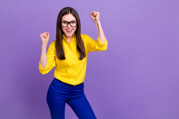 Portrait of attractive cheerful lucky girl rejoicing having fun isolated over bright violet purple color background