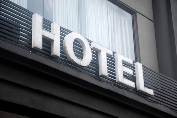 Hotel sign on generic modern city hotel building facade