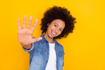 Portrait of attractive cheerful teen-aged girl giving five perfect isolated over bright yellow...