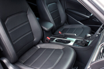 Interior of prestige modern car. Comfortable leather seats. The driver and front passenger seat of...