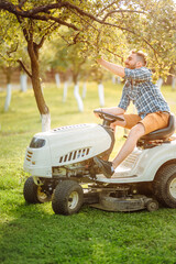 Professional gardner using lawn mower and premium tools for grass cutting