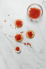 Delicious red caviar appetizer cracker, butter and red caviar. banner, menu, recipe. selective focus, place for text