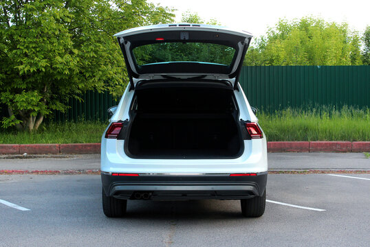 Open back door white car. Modern SUV open trunk. Trunk car.