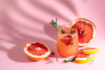 Summer cocktail with grapefruit, rosemary, and ice.
