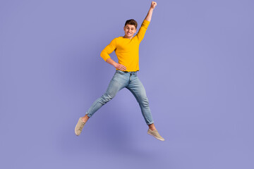 Fototapeta na wymiar Full body photo of young cheerful guy superman strong wear casual clothes isolated over violet color background