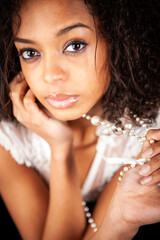 Lace and pearls: close portrait. An intimate portrait of a beautiful young female model. Part of a...