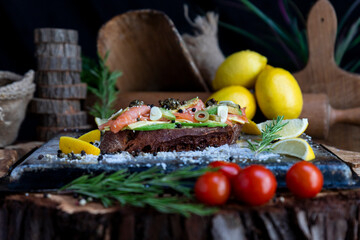 Salted salmon open sandwich with guacamole, avocado, olives, cheese, pesto and garlick. Healthy seafood
