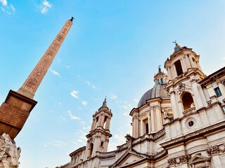 Fototapeta na wymiar Obelisk and old cathedral in rome italy