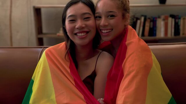 Smiling bisexual couple with pride flag