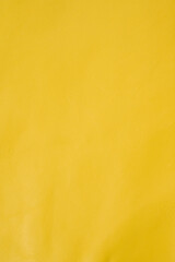 Obraz premium Yellow roll of genuine leather. Wallpaper. Yellow leather for shoes and bags