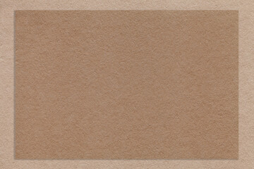 Texture of craft brown color paper background with beige border, macro. Structure of vintage dense...
