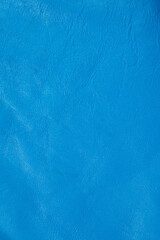 Blue roll of genuine leather. Wallpaper. Blue leather for shoes and bags