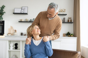 Smiling married couple resting together at home