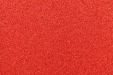 Texture of red and rubby colors paper background, macro. Structure of dense craft cardboard.