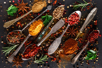 Various spices a vintage spoons on stone table. Colorful Herbal and Spices Oriental marketplace.Top...