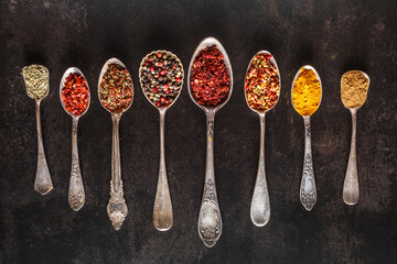 Various spices a vintage spoons on stone table. Colorful Herbal and Spices Oriental marketplace.Top...
