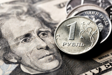 Russian ruble coin on background of dollar bill.Concept of ruble devaluation, inflation in Russia.The concept of depreciation, sanctions, financial crisis, war.Stop war.