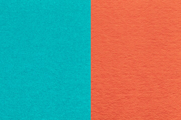 Fototapeta premium Texture of craft cerulean and orange paper background, half two colors, macro. Structure of vintage dense cyan cardboard.