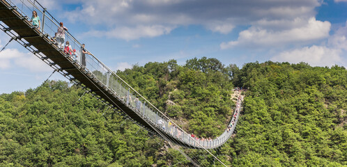 Panorama of tourists crossing the suspension bridge in Geierlay