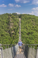 People crossing the Geierlay suspension bridge in Morsdorf, Germany