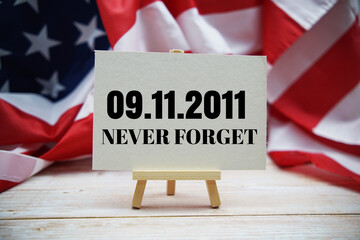 911 Never Forget text messege  with USA flag on wooden background