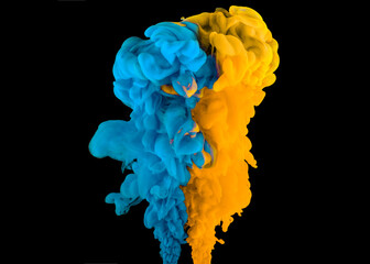 Blue and yellow paint clouds in water isolated on black background. Acrylic colors and ink in...