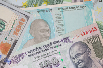 Indian rupee banknotes among dollars and euro banknotes