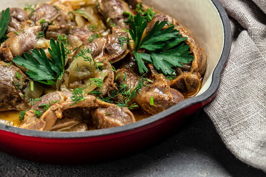 Stewed chicken stomach, Traditional Korean spicy chicken gizzard with onions, garlic, chili and sesame on a dark background, place for text, top view