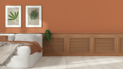 Bedroom interior design background with copy space, wooden panel with shutters, plaster wall in white and orange tones with pictures. Bed with blanket. Parquet, plant, interior design