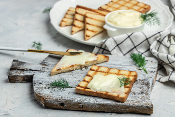 Sliced bread with cream cheese and butter for breakfast. melted cheese sandwich on light background. banner, menu, recipe place for text, top view