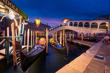Rialto Bridge and gondola at night, Venice, Italy