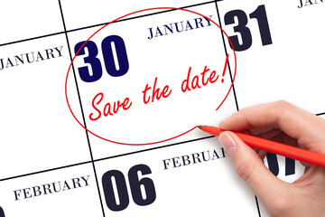 Hand drawing red line and writing the text Save the date on calendar date January 30.