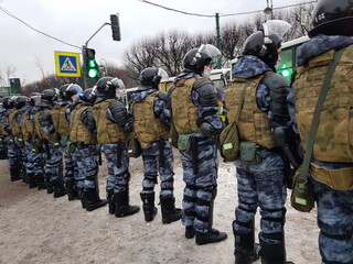 Russian police in protective gear opposes the demonstrators during opposition protests